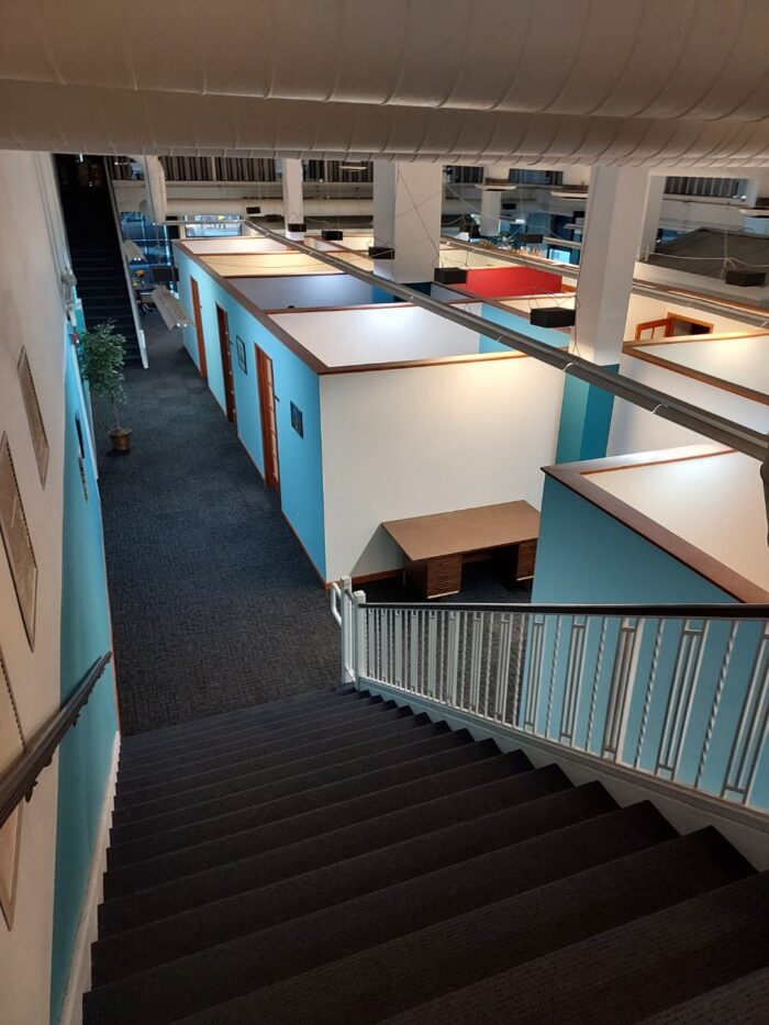 Stairs leading down to a couple rows of office spaces for rent with 17th & Central Executive Suites.