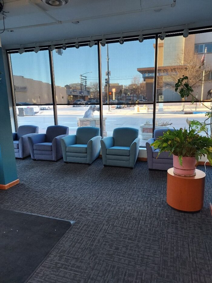 A row of chairs against windows looking out onto downtown Cheyenne, Wyoming from the offices of Wyoming Registered Agent.